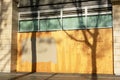 Exterior of business, store, restaurant boarded up with plywood sheets. Plywood shutters prevent unauthorized access by squatters Royalty Free Stock Photo