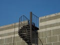 Exterior cantilevered metal spiral staircase