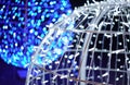 Exterior Christmas decoration - blue and white led light chains arranged over large balls - closeup abstract detail, only few Royalty Free Stock Photo