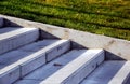 exterior concrete stair closeup in public park. lush green grass on the side.