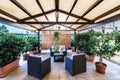 Exterior covered patio with furniture and plantes