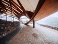 Exterior details of a city concert hall made from wood, stone and metal material. Nobody. Mist in the background. Modern design Royalty Free Stock Photo