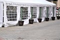 Exterior dining tent with transparent windows set up in empty parking lot