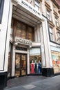 Exterior entrance to Monsoon fashion clothing store showing doors, logo and branding