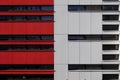 Exterior facade of modern building with detail of red and white aluminium panels. Royalty Free Stock Photo