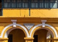 Exterior facade of an old vintage Portuguese era building painted yellow with arches in Panaji