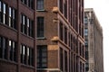 Exterior facade of pre-modern 1900`s architectural style commercial business office buildings downtown in city, brick, stone
