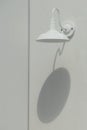 Exterior Gooseneck Barn Light Fixture and Its Shadow on White Plastered Wall