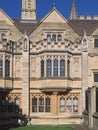 Exterior of gothic style building with gables and leaded glass windows