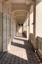 Exterior hallway of Christian church with sunlight, shadow