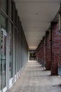 Exterior hallway with red brick columns and tiled floor