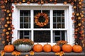 exterior of a house is decorated with harvest of pumpkins and leaves for halloween holiday, window and brick wall, autumn