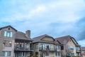 Exterior of houses against dense cloudy sky on a scenic suburban neighborhood