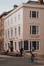 Exterior of The Kings Arms pub in Oxford, UK, cyclists riding past, motion blur Royalty Free Stock Photo