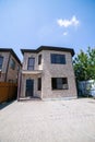 Exterior of a large two story brick residential home containing plenty of copy space Royalty Free Stock Photo