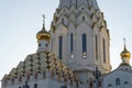 Exterior of a large white Christian church with lots of gilding, domes and crosses against a bright sky Royalty Free Stock Photo