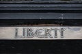 Exterior of Liberty department store at night in Regent Street showing its name sign