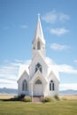 Exterior of little white country church building on a sunny day with white clouds Royalty Free Stock Photo