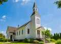 Exterior of a Little White Country Church on a Sunny Day and blue sky at the background. Beautiful traditional church in rural Royalty Free Stock Photo