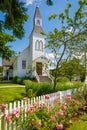 Exterior of a Little White Country Church on a Sunny Day and blue sky at the background. Beautiful traditional church in rural Royalty Free Stock Photo