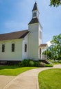 Beautiful traditional church in rural. Exterior of a Little White Country Church on a Sunny Day and blue sky background Royalty Free Stock Photo
