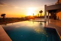 Exterior of a luxury villa with a blue swimming pool at sunset. Generative ai Royalty Free Stock Photo