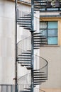 Exterior metal spiral fire escape staircase at the rear of a building Royalty Free Stock Photo