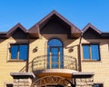 Exterior of modern brick house with forgery balcony, windows and rain gutters