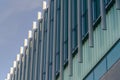 Exterior of a modern building with vertical sunshades outside the glass windows Royalty Free Stock Photo