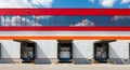 Industrial Warehouse Exterior with Loading Docks and Red and Orange Accents building logistics Royalty Free Stock Photo