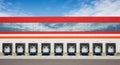 Warehouse Loading Docks with Red and Orange Stripes Under Blue Sky industrial building Royalty Free Stock Photo