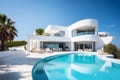 Exterior of modern minimalist white villa with pool. A luxurious house with curved shapes, located on the coast of the ocean.