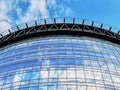 Exterior of a modern office building. In windows reflect the blue sky with clouds Royalty Free Stock Photo