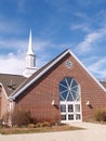 Exterior of a modern red brick church and steeple Royalty Free Stock Photo