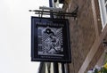 The exterior mount pub sign outside The Friar Penketh public house part of the Wetherspoon chain of pubs in