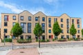 Exterior of a new brick apartment block along a ee lined street