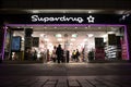 Exterior Night Shot of Illuminated entrance to Superdrug Store