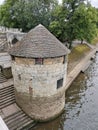 Exterior of North Street Postern medieval Tower with trees by the lake