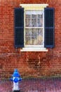 Exterior old brick wall with window and fire hydrant Royalty Free Stock Photo