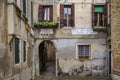 Exterior of an old building with shutters and an archway in Venice Italy Royalty Free Stock Photo