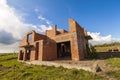 Exterior of an old building under construction. Orange brick walls in a new house. Royalty Free Stock Photo