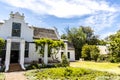 Exterior of an old white house in the style of the Dutch Cape architecture in Stellenbosch, Western Cape, South Africa