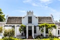 Exterior of an old white house in the style of the Dutch Cape architecture in Stellenbosch, Western Cape, South Africa