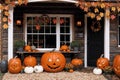 exterior of the old wooden house is decorated with harvest of pumpkins and leaves for halloween holiday, door and window, autumn