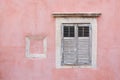 Exterior pink wall with shuttered wooden window Royalty Free Stock Photo