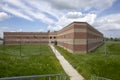 Exterior of prison cell block with overgrown yard Royalty Free Stock Photo