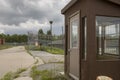 Exterior of prison guard house with overgrown yard