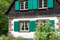 Quaint German cottage with green shutters Royalty Free Stock Photo