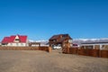 Exterior of ranch home with open gate and car in the yard. A house in the Altai Mountains, Kosh-Agach, Siberia, Russia Royalty Free Stock Photo
