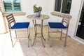 Exterior Rear Patio With High Table And Two Chairs With Blue Cushions Royalty Free Stock Photo